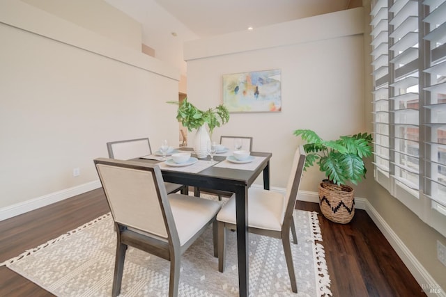 dining area with baseboards and dark wood-style flooring