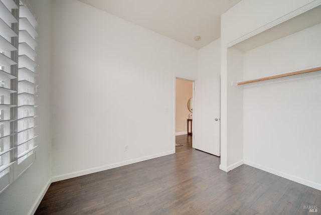 unfurnished bedroom featuring dark wood finished floors and baseboards