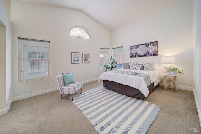 bedroom featuring light carpet, high vaulted ceiling, and baseboards