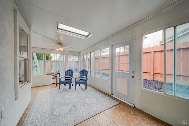 sunroom featuring a skylight and a ceiling fan