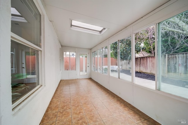 unfurnished sunroom with a skylight