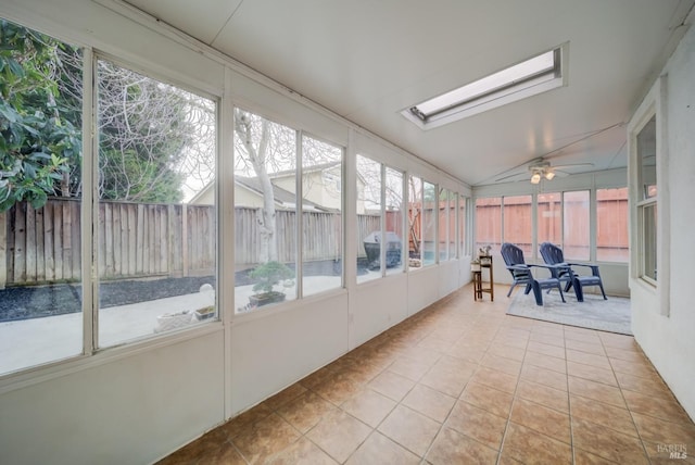 sunroom / solarium with vaulted ceiling with skylight