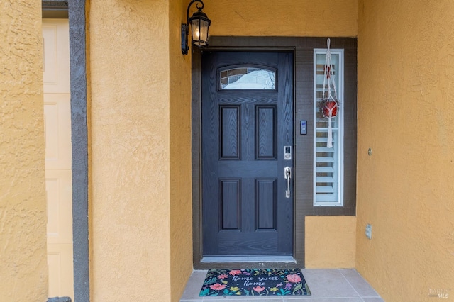 entrance to property with stucco siding