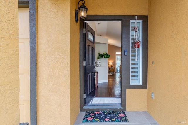 property entrance with stucco siding