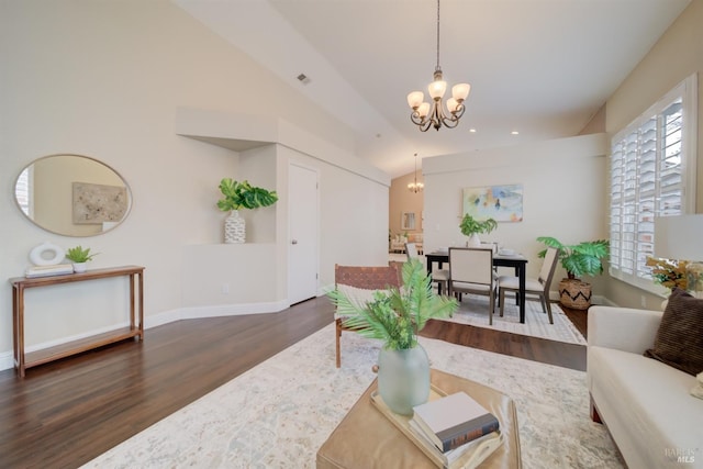 living area featuring dark wood-style flooring, lofted ceiling, visible vents, an inviting chandelier, and baseboards