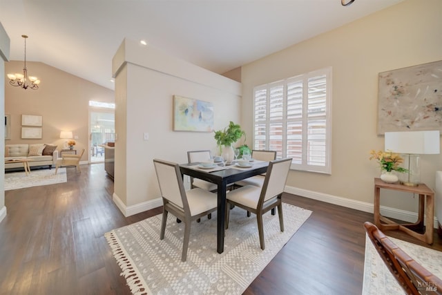 dining room with dark wood finished floors, vaulted ceiling, a notable chandelier, and baseboards