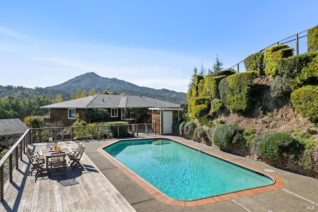 outdoor pool featuring fence and a mountain view