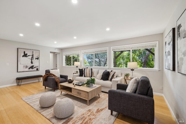 living room with light wood finished floors, baseboards, and recessed lighting