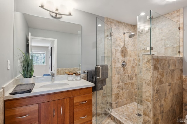 bathroom featuring a stall shower and vanity