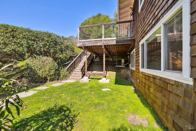 view of yard featuring stairs, a deck, and cooling unit