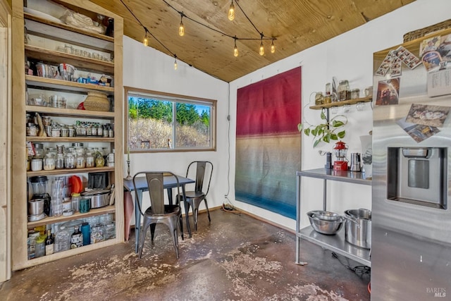 dining space featuring baseboards, lofted ceiling, wood ceiling, rail lighting, and concrete floors