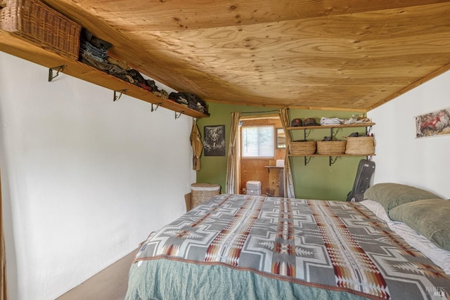 bedroom with lofted ceiling and wood ceiling