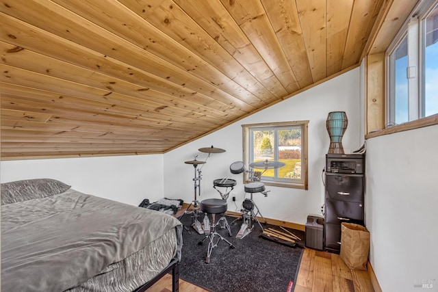 bedroom featuring hardwood / wood-style flooring, wood ceiling, baseboards, and vaulted ceiling