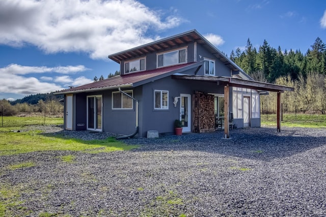 exterior space with metal roof and stucco siding