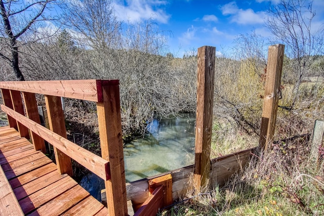 wooden deck featuring a forest view