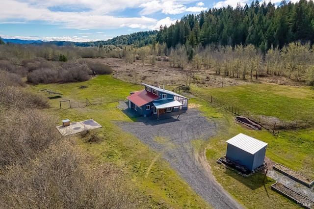 bird's eye view with a view of trees and a rural view