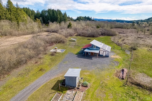 birds eye view of property with a forest view and a rural view