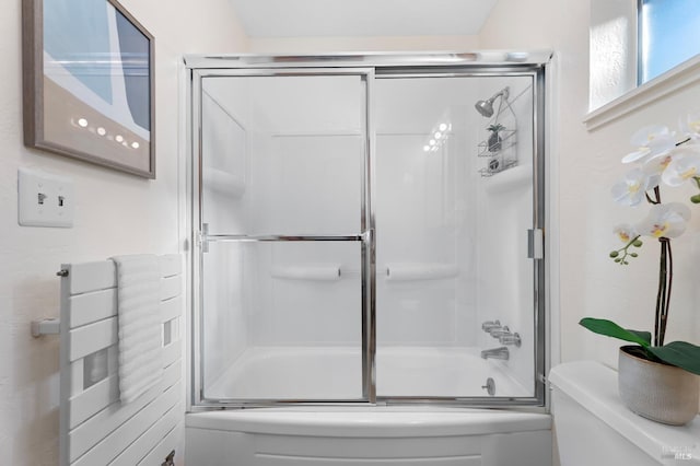 full bathroom with enclosed tub / shower combo and toilet