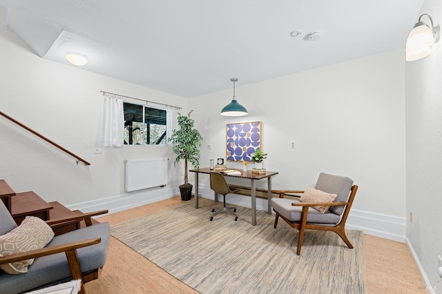 dining room featuring baseboards and radiator heating unit