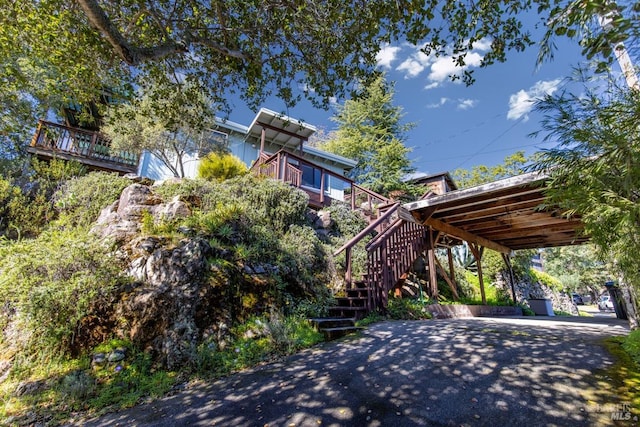 exterior space with driveway, stairway, and a carport