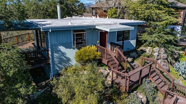 view of front of property with stairs and a wooden deck