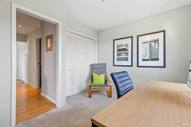 office featuring baseboards and light colored carpet