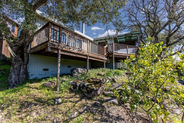 rear view of property featuring crawl space and a deck