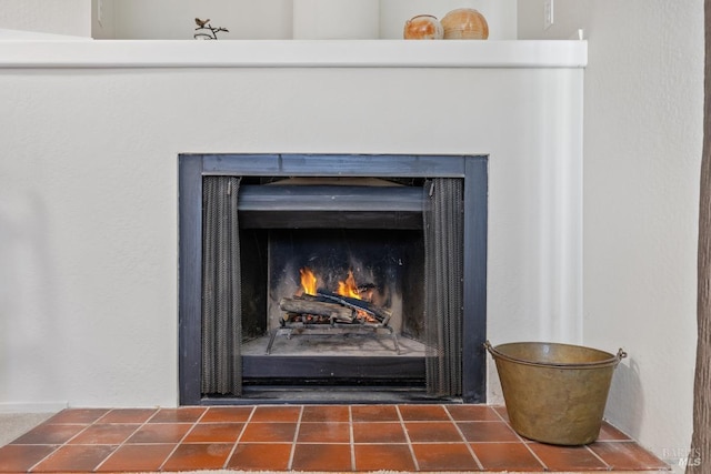 interior details with a lit fireplace