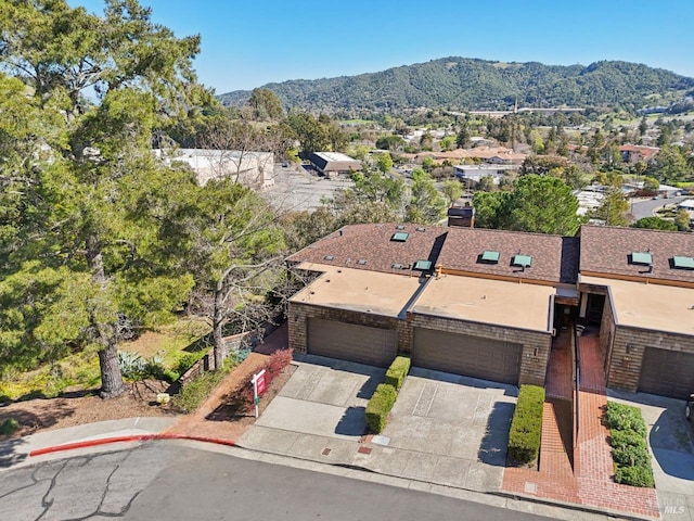 drone / aerial view featuring a residential view and a mountain view