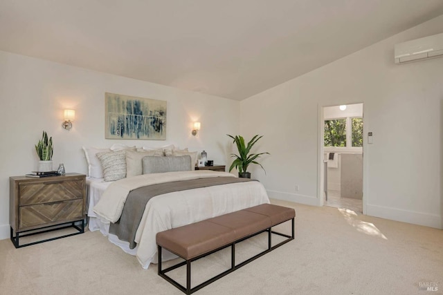 bedroom with lofted ceiling, light colored carpet, ensuite bathroom, an AC wall unit, and baseboards