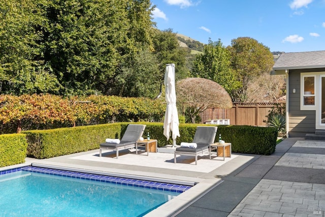 view of pool featuring a patio, fence, and a fenced in pool