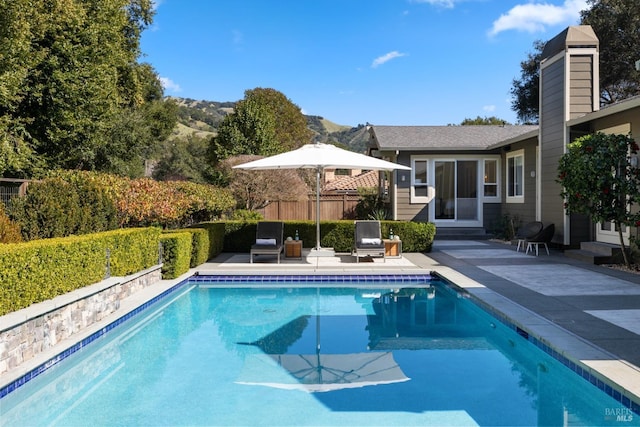 view of pool with entry steps, a patio area, fence, and a fenced in pool