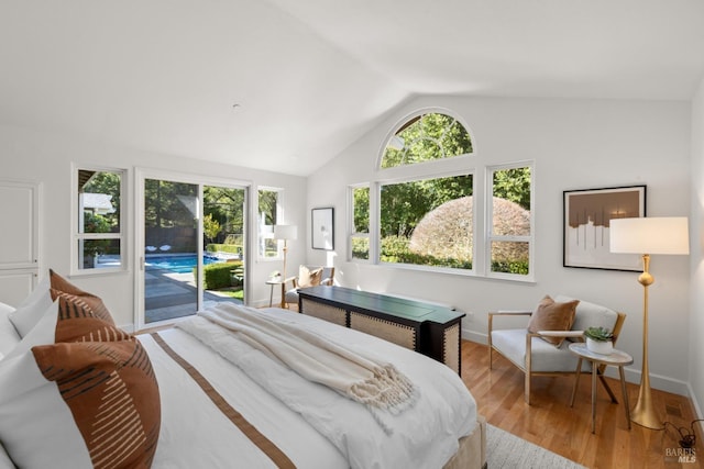 bedroom with vaulted ceiling, light wood-style floors, baseboards, and access to exterior