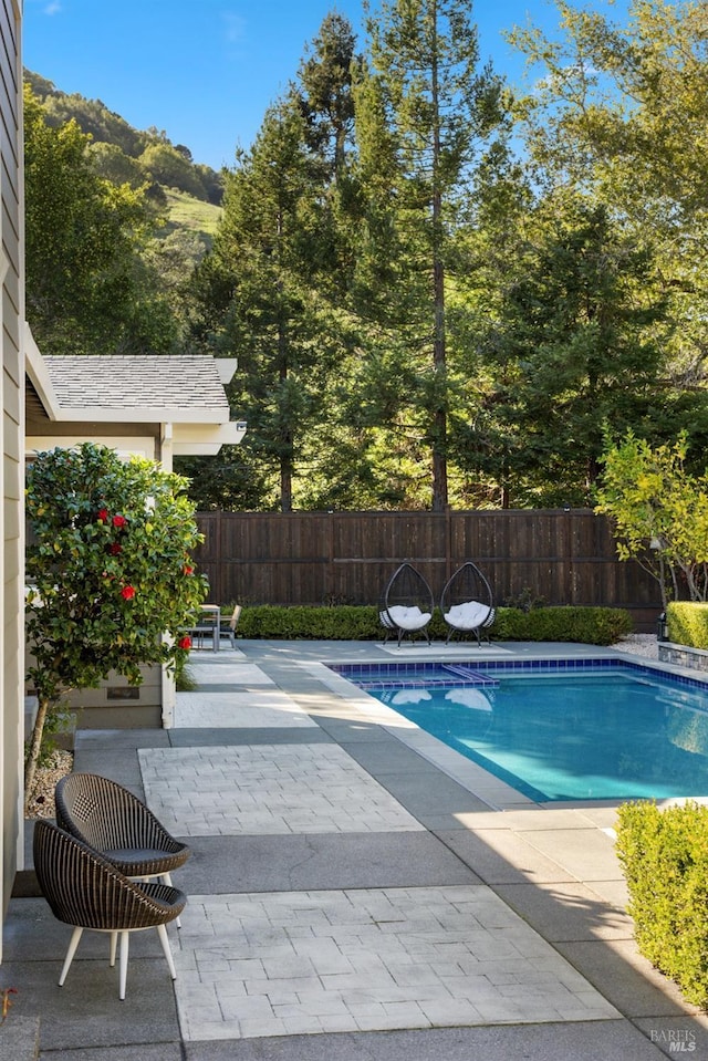 view of pool with a fenced in pool, fence, and a patio