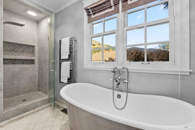 bathroom with radiator heating unit, tile patterned floors, crown molding, a freestanding bath, and a shower stall