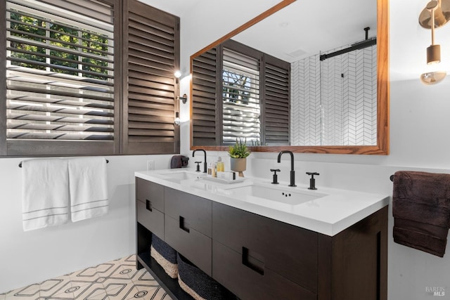 full bathroom featuring double vanity and a sink