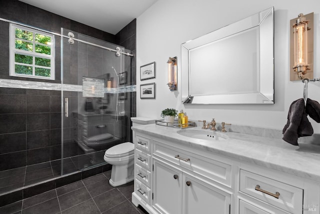 bathroom featuring toilet, tile patterned floors, a shower stall, and vanity