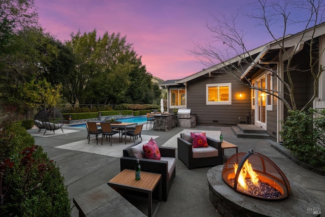 patio terrace at dusk with a fenced in pool, an outdoor living space with a fire pit, a grill, and fence