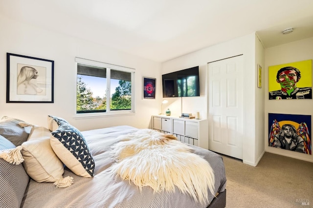 bedroom with baseboards and light colored carpet