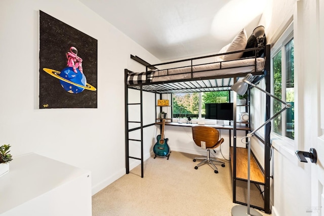 bedroom featuring baseboards, multiple windows, and carpet