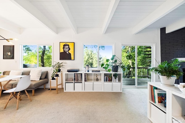 sitting room featuring beam ceiling, carpet flooring, and a healthy amount of sunlight