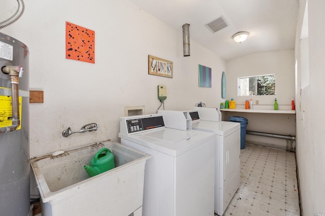 clothes washing area featuring light floors, washing machine and dryer, visible vents, and a sink