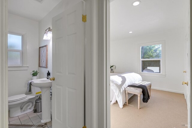 bathroom featuring baseboards, tile patterned flooring, toilet, and recessed lighting