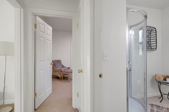 hall featuring light colored carpet