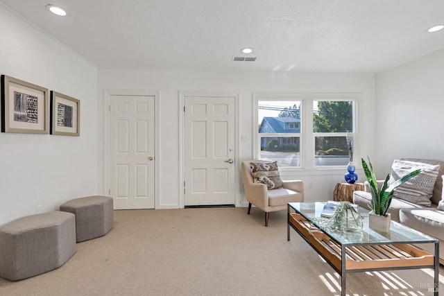 sitting room featuring light carpet, visible vents, and recessed lighting