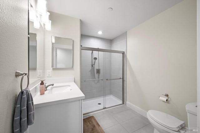 bathroom with toilet, a stall shower, tile patterned flooring, and vanity