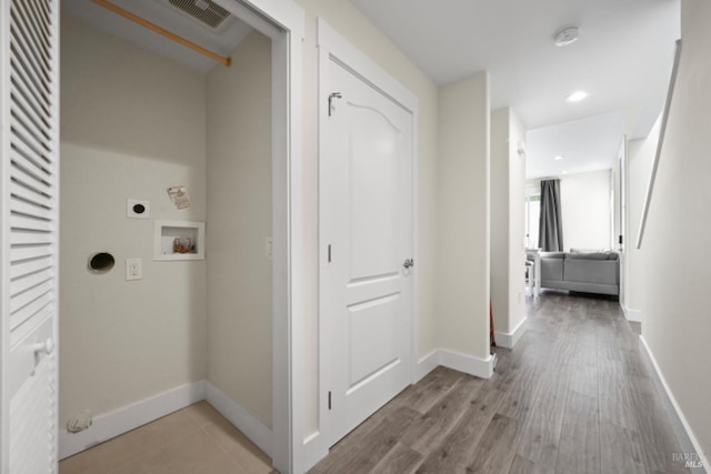 hallway with recessed lighting, visible vents, baseboards, and wood finished floors