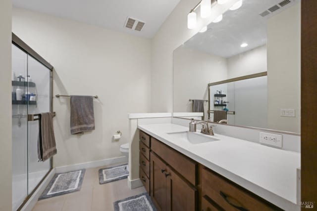 full bath with a stall shower, tile patterned flooring, visible vents, and vanity