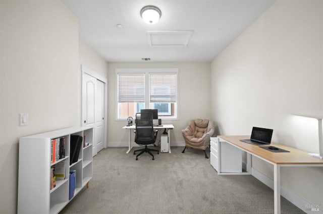 office area with attic access, light carpet, visible vents, and baseboards