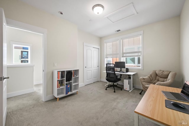 office area featuring attic access, visible vents, baseboards, and light colored carpet